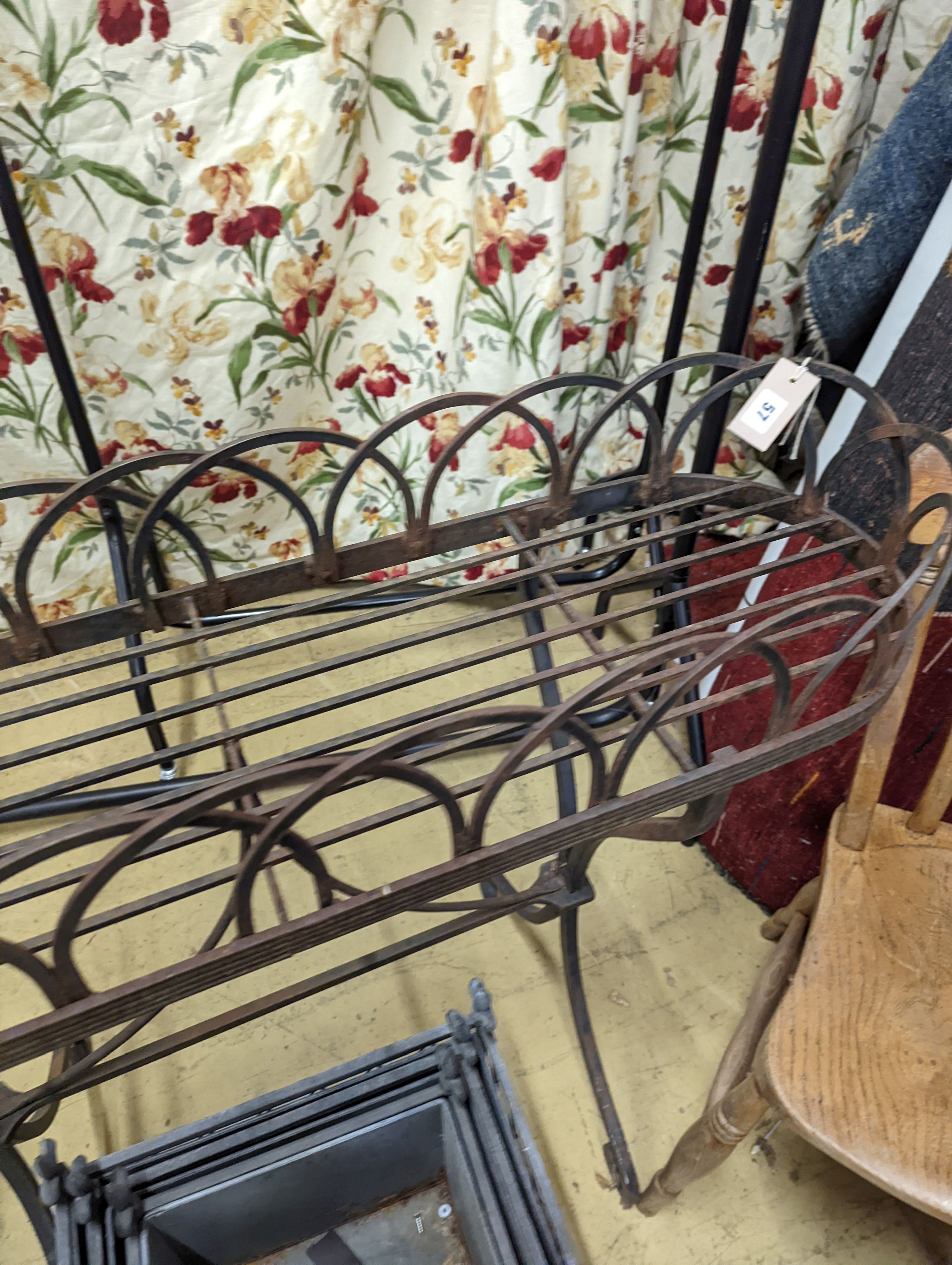 A Victorian style wrought iron pot stand, width 110cm, height 95cm, together with a graduated set of three square metal planters